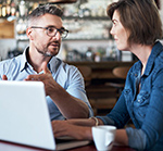 Two people chatting over a cup of coffee.