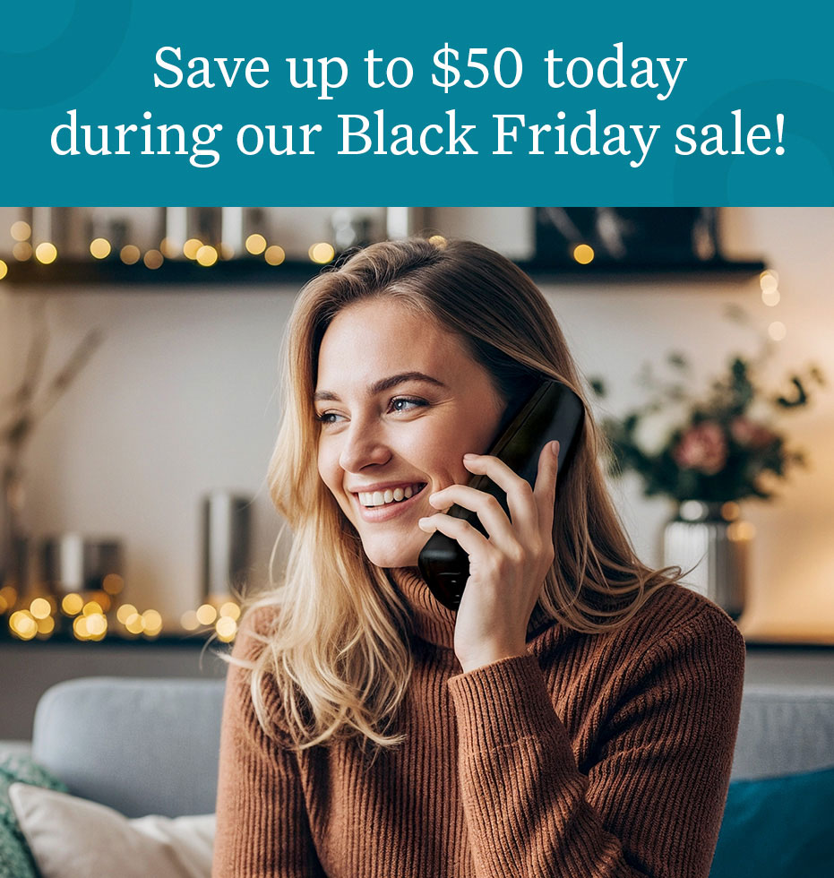 Woman talking by an Ooma Retro Pink Phone.