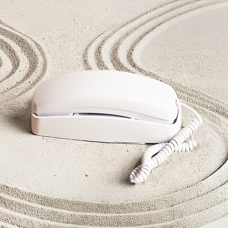 An image of Ooma Telo with Retro White Phone on a table.