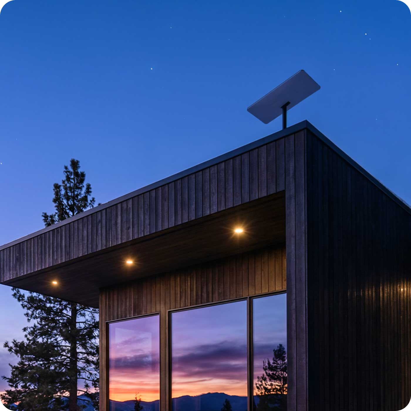 Starlink dish on the roof of a modern cabin at dusk