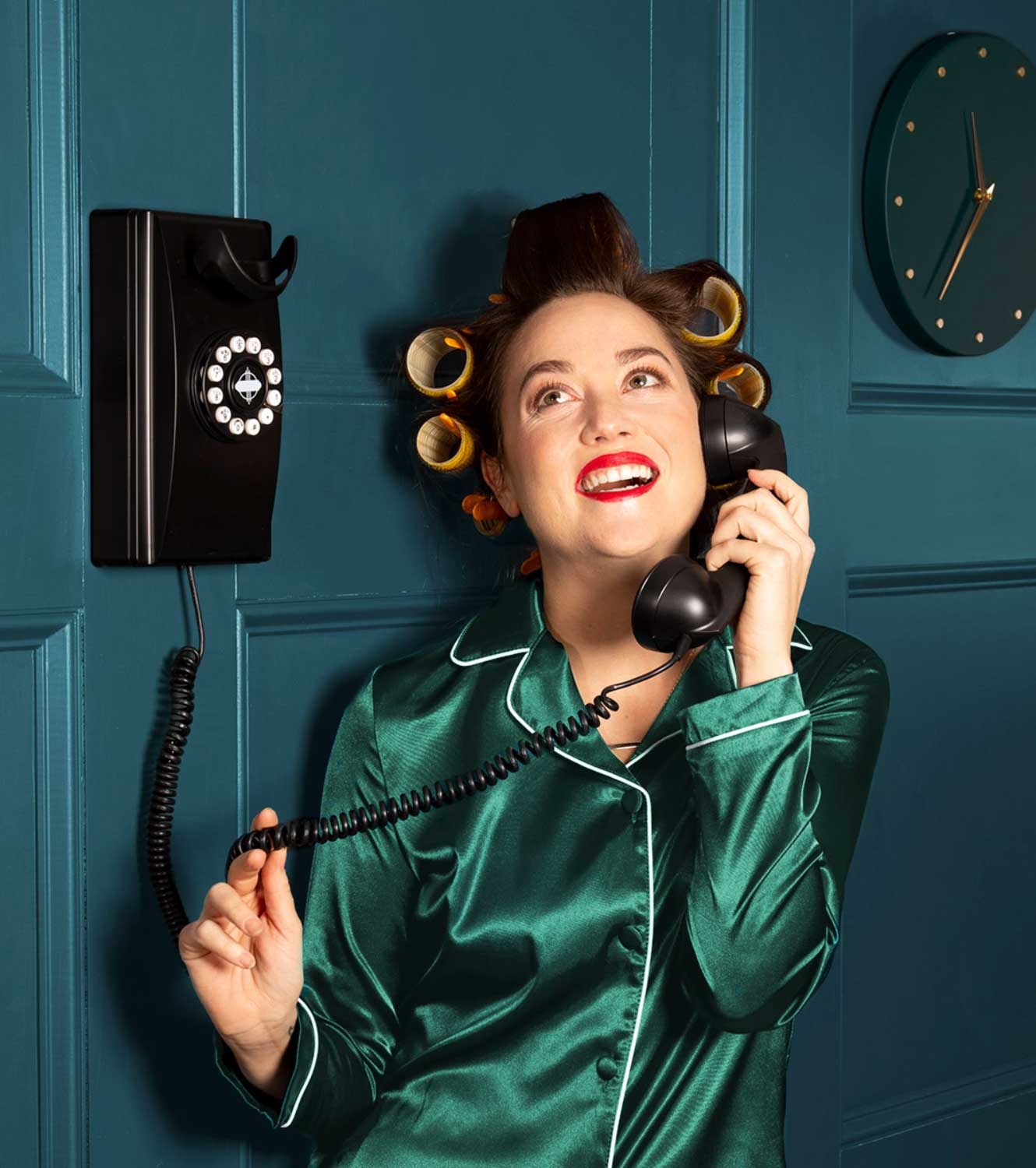 Ooma Home Phone Service Hero Image - A woman using old analog phone to connect using Ooma Telo VoIP Service