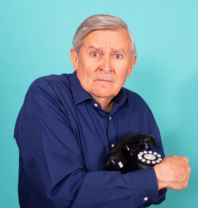 old man holding old landline phone