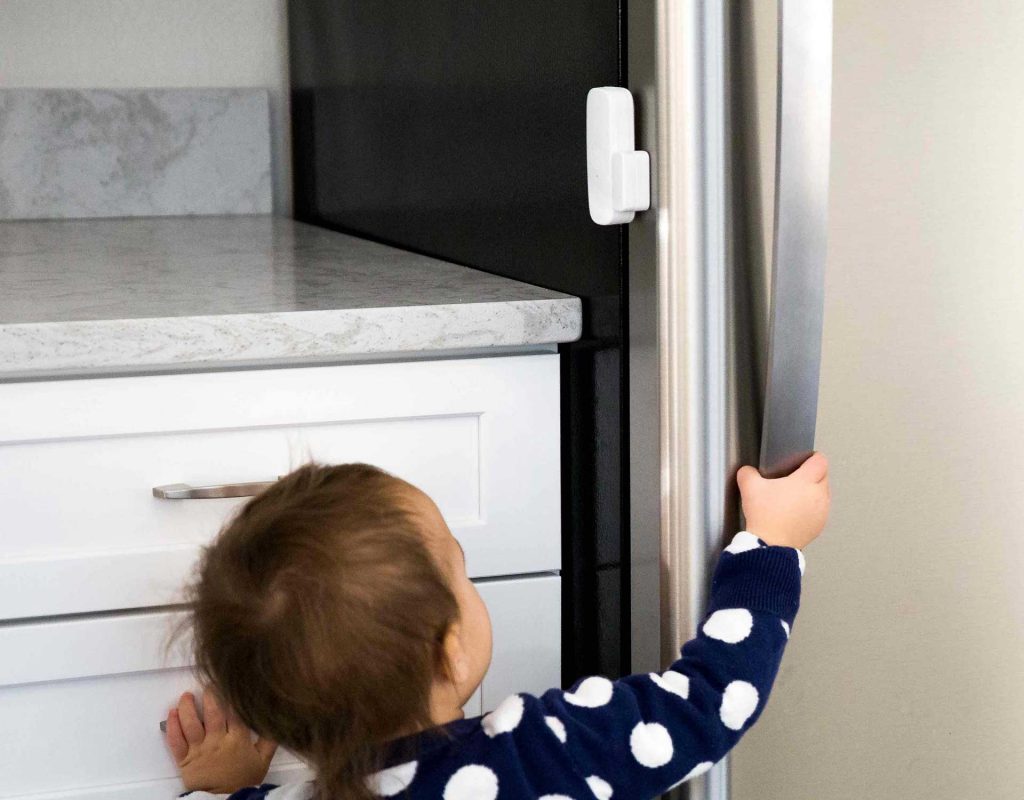 Image of child trying to open the fridge