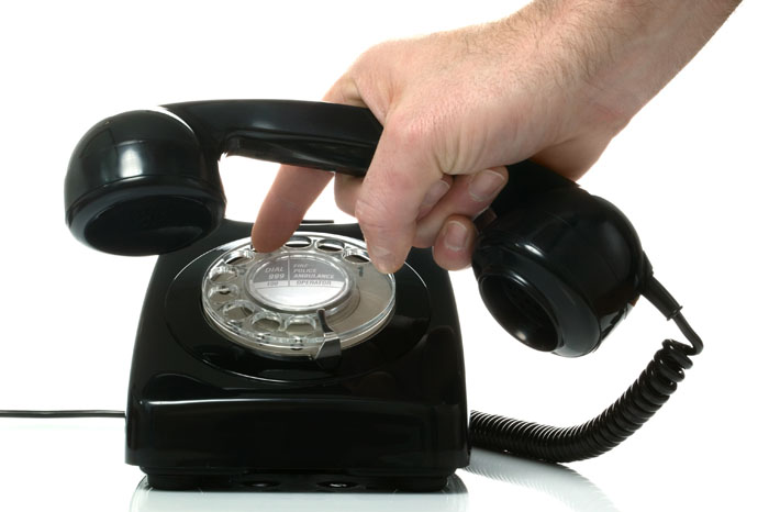 Details with a white old fashioned dial rotary phone from the