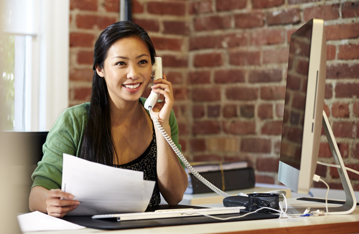 Business woman on the phone working with financial documents